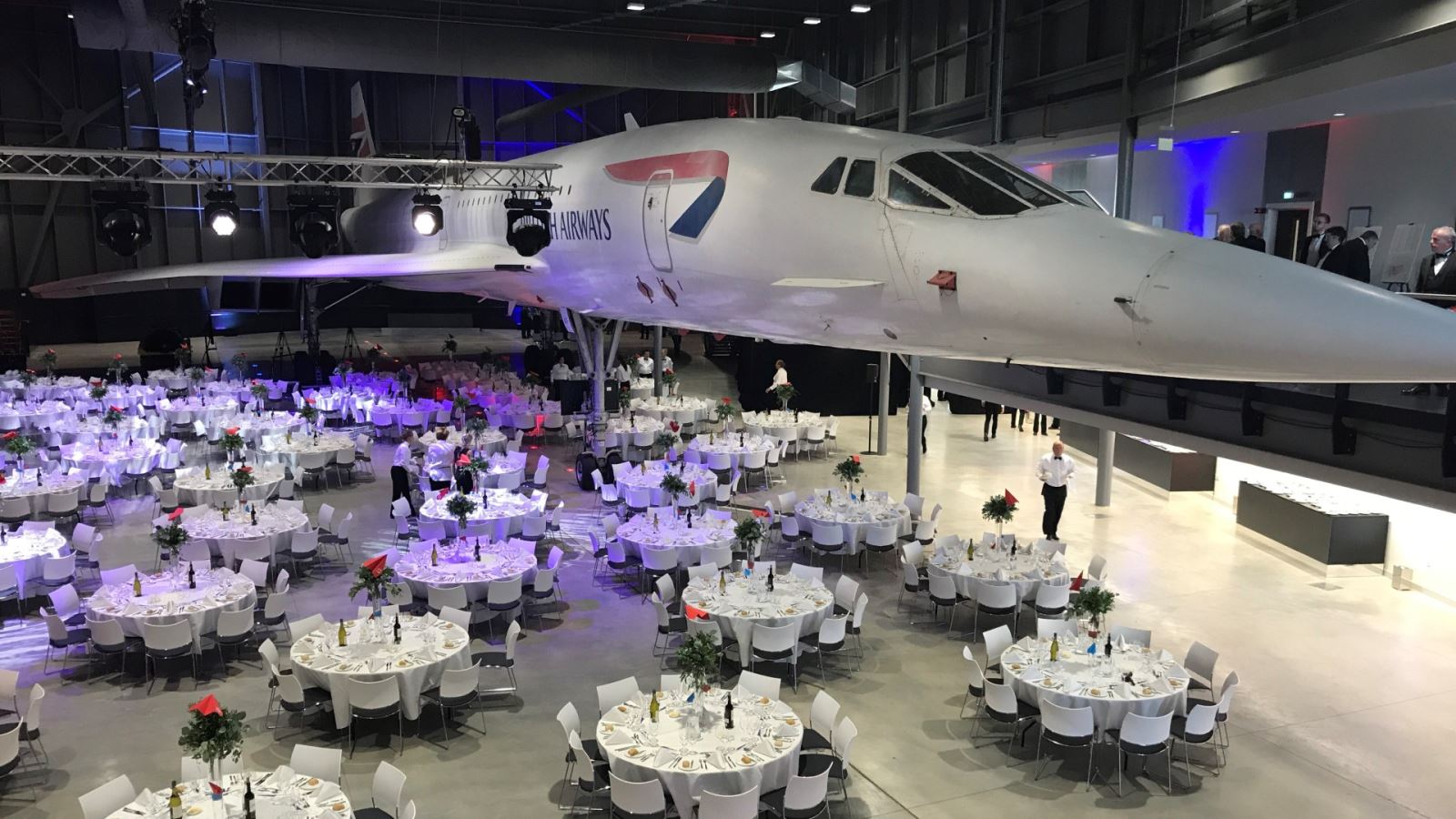 Dinner tables set up around Concorde at Aerospace Bristol